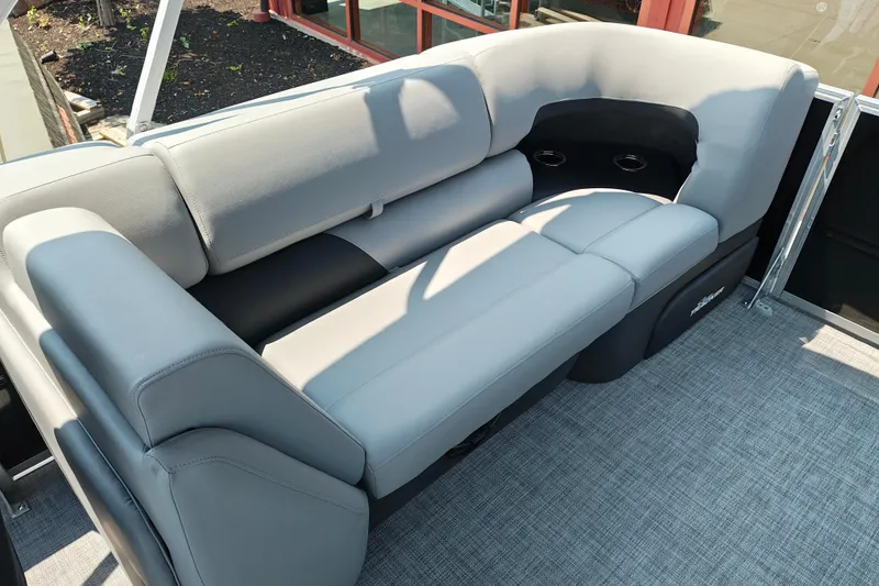 Slide: The Image of 2026 Sun Tracker Party Barge 24 XP3 with comfortable gray seating and cup holders. - 24