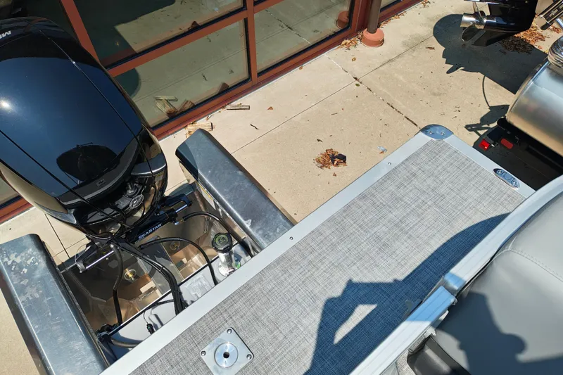 Slide: The Image of 2026 Sun Tracker Party Barge 24 XP3 pontoon boat with motor, docked on concrete. - 26