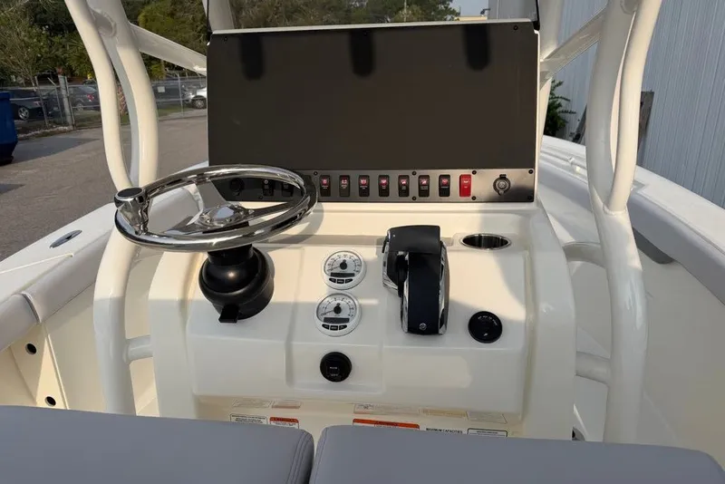 Slide: The Image of Center console of 2026 Mako 226 boat with steering wheel and control panel. - 69