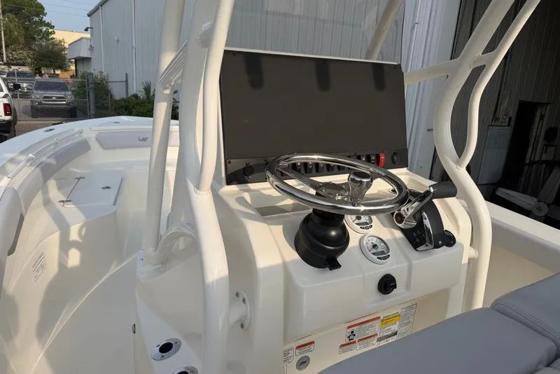 Slide: The Image of 2026 Mako 226 Center Console boat interior with steering wheel and control panel. - 65
