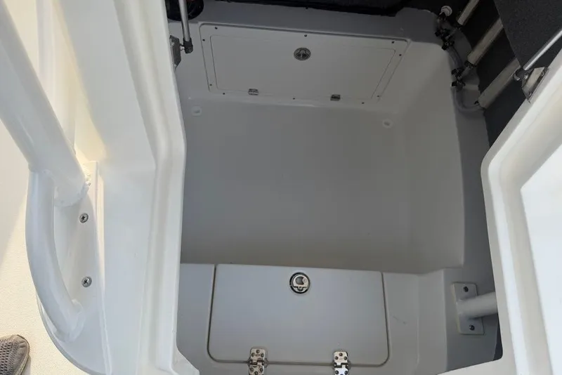 Slide: The Image of Storage compartment of 2026 Mako 226 Center Console boat, featuring secure latches and clean design. - 67