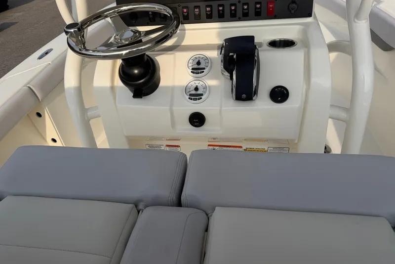 Slide: The Image of 2026 Mako 226 Center Console boat dashboard with steering wheel and controls. - 68