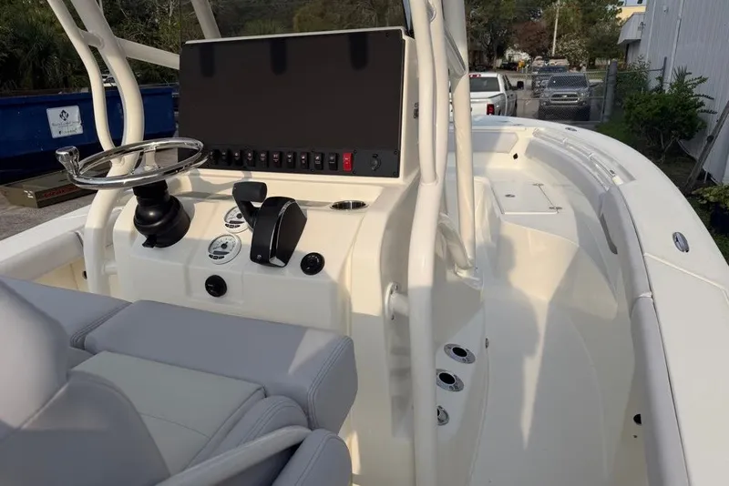 Slide: The Image of 2026 Mako 226 Center Console boat interior with steering wheel and control panel. - 64