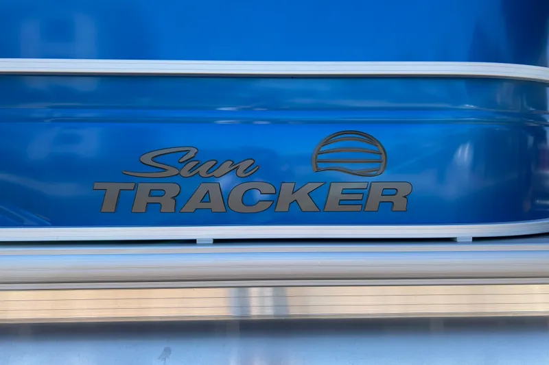 Slide: The Image of Sun Tracker Party Barge 20 DLX 2026 logo on blue background. - 21