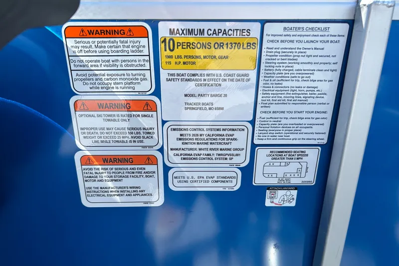 Slide: The Image of Warning and capacity labels on a 2026 Sun Tracker Party Barge 20 DLX boat. - 16