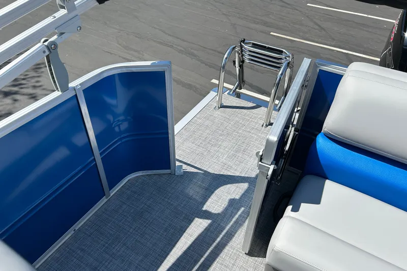 Slide: The Image of 2026 Sun Tracker Party Barge 20 DLX interior with blue paneling and seating. - 15