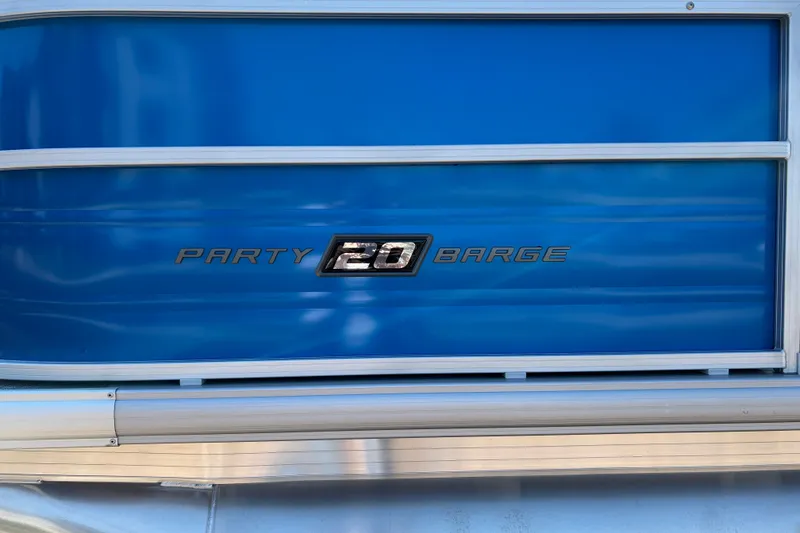 Slide: The Image of 2026 Sun Tracker Party Barge 20 DLX, blue exterior detail. - 20