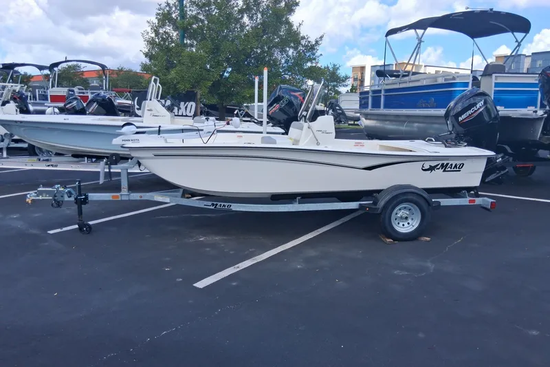 The Image of 2026 Mako Pro Skiff 15 CC boat on trailer in parking lot. - 0