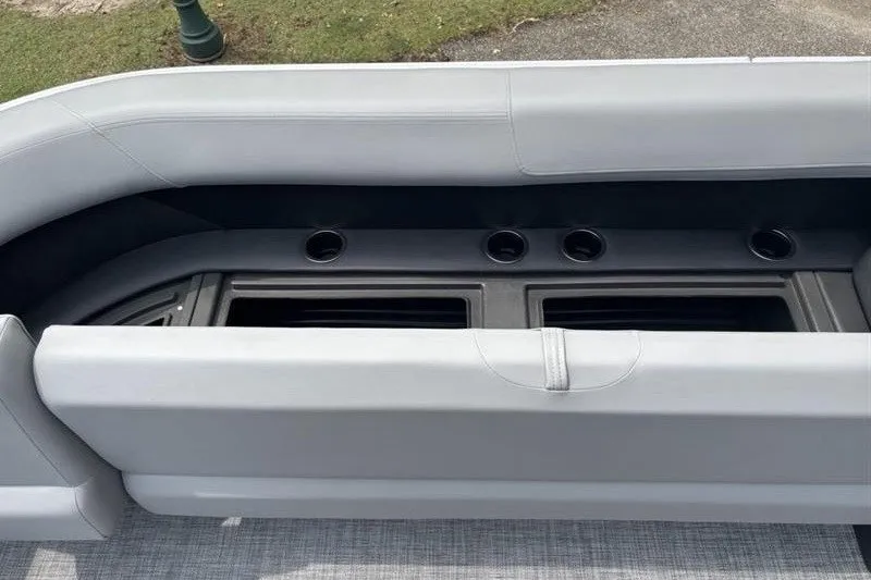 Slide: The Image of 2026 Sun Tracker Party Barge 18 DLX interior seating with storage compartments. - 16