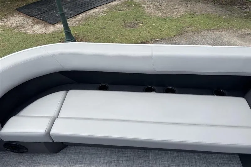Slide: The Image of 2026 Sun Tracker Party Barge 18 DLX seating area with cup holders, gray upholstery. - 15