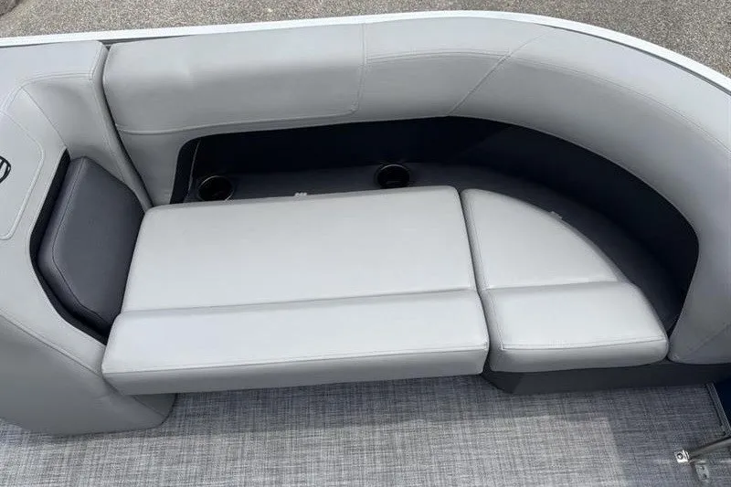 Slide: The Image of 2026 Sun Tracker Party Barge 18 DLX interior seating with gray upholstery and cup holders. - 13
