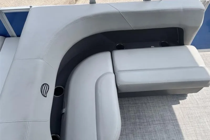 Slide: The Image of 2026 Sun Tracker Party Barge 18 DLX, featuring sleek gray seating and cup holders. - 19