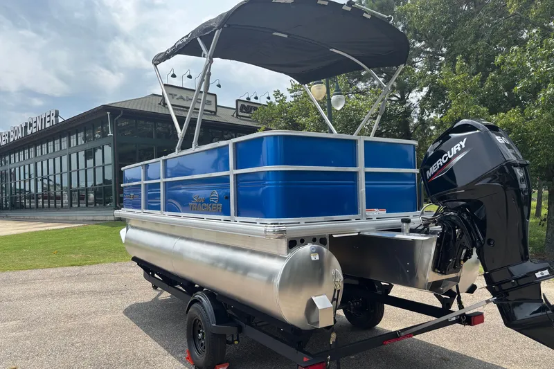 Slide: The Image of 2026 Sun Tracker Party Barge 18 DLX pontoon boat with Mercury engine at dealership. - 7