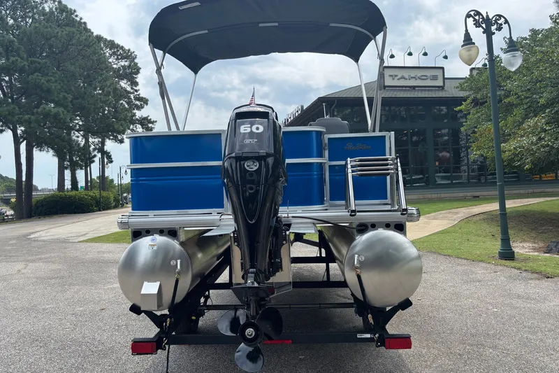 Slide: The Image of 2026 Sun Tracker Party Barge 18 DLX pontoon boat with 60 HP engine, parked outdoors. - 5
