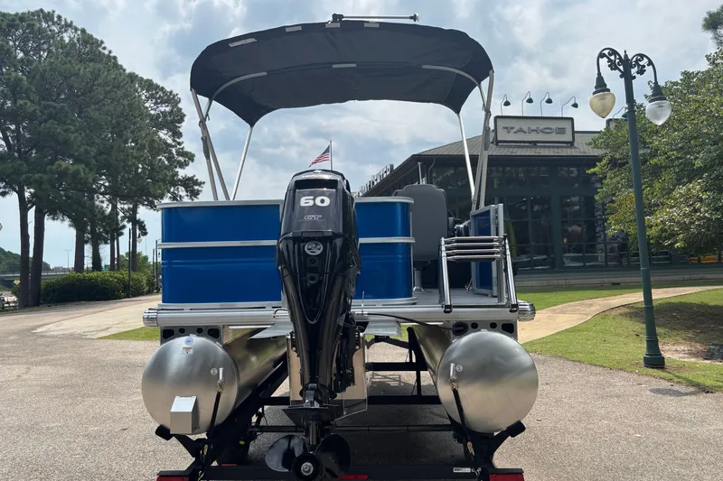 Slide: The Image of 2026 Sun Tracker Party Barge 18 DLX pontoon boat with 60 HP engine, parked outdoors. - 6