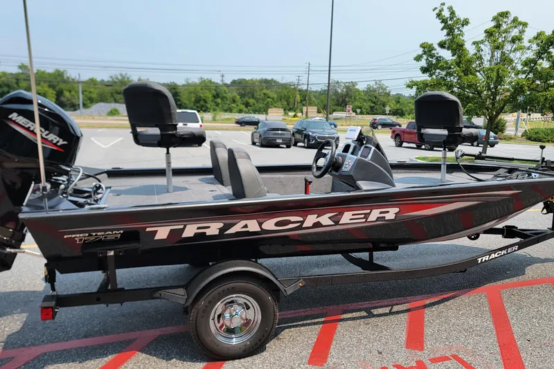 Slide: The Image of 2025 Tracker Pro Team 175 boat on trailer in parking lot. - 2