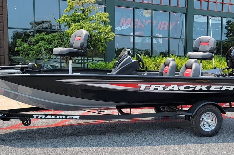 The Image of 2025 Tracker Pro Team 175 boat on trailer, parked outside dealership. - 0