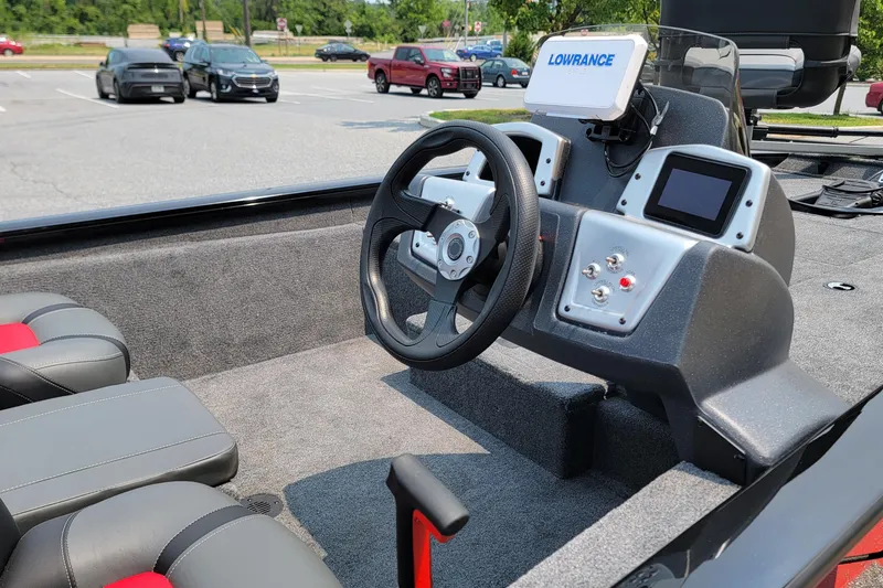 Slide: The Image of Interior of 2025 Tracker Pro Team 175 boat with steering wheel and control panel. - 4