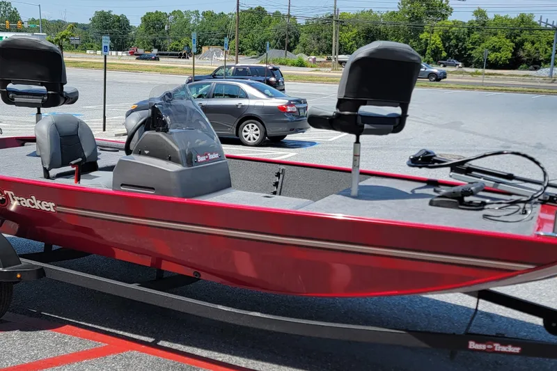 Slide: The Image of 2025 Tracker Bass Tracker Classic XL boat in parking lot, red exterior, modern design. - 2