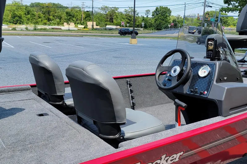 Slide: The Image of 2025 Tracker Bass Tracker Classic XL boat interior with steering wheel and seats. - 4