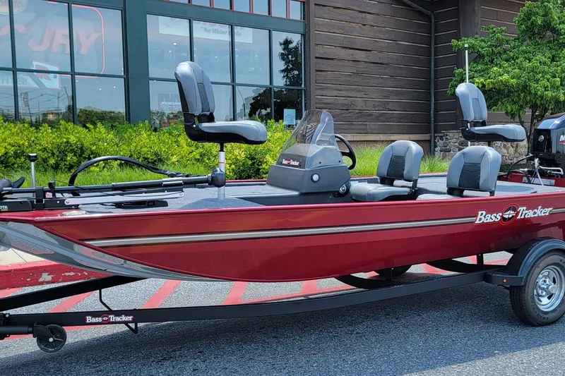 The Image of 2025 Tracker Bass Tracker Classic XL boat in red, parked outside a building. - 0