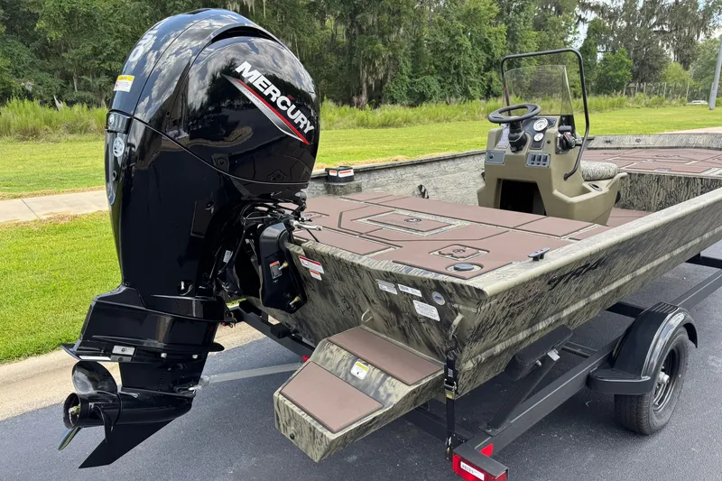Slide: The Image of 2026 Tracker Grizzly 2072 CC boat with Mercury outboard motor on a trailer. - 11