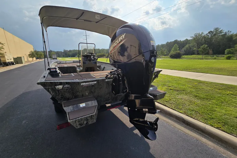 Slide: The Image of 2026 Tracker Grizzly 2072 CC boat with Mercury outboard motor on a sunny day. - 6