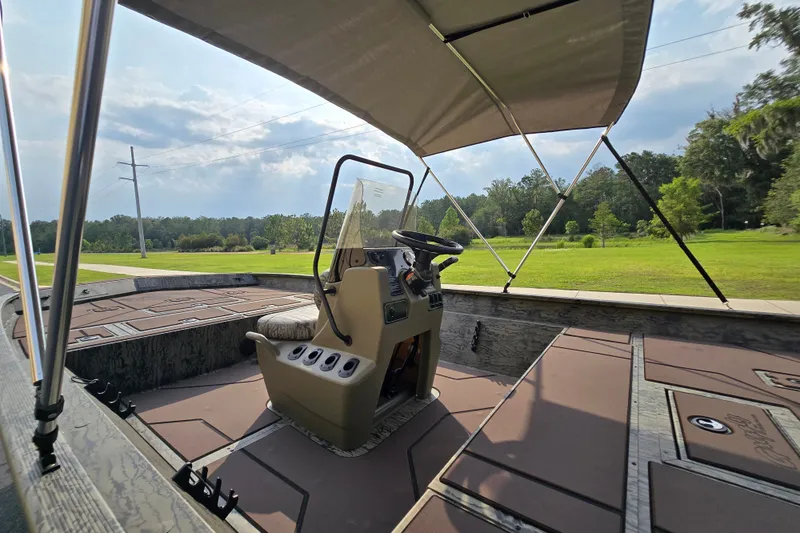 Slide: The Image of 2026 Tracker Grizzly 2072 CC boat interior with canopy, steering console, and spacious deck. - 7