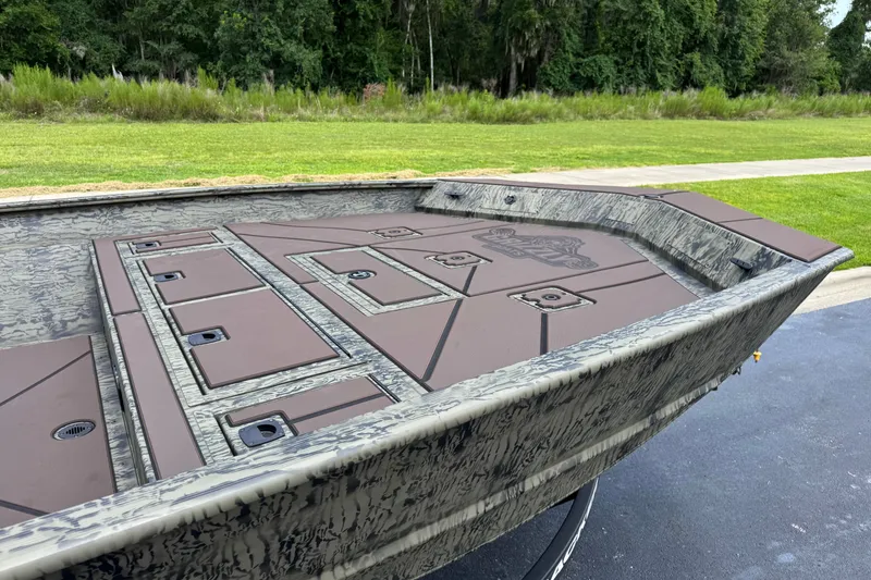 Slide: The Image of 2026 Tracker Grizzly 2072 CC boat with camo design, featuring spacious deck and storage compartments. - 13