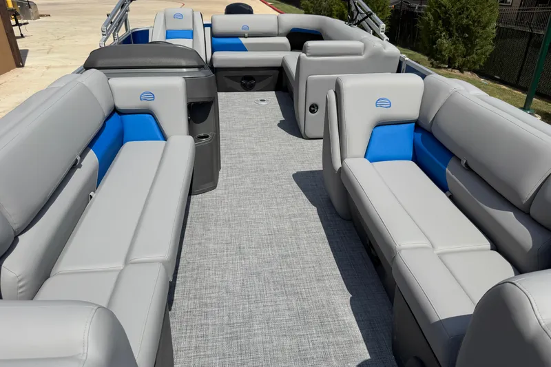 Slide: The Image of 2026 Sun Tracker Party Barge 20 DLX interior with gray and blue seating, spacious layout. - 15