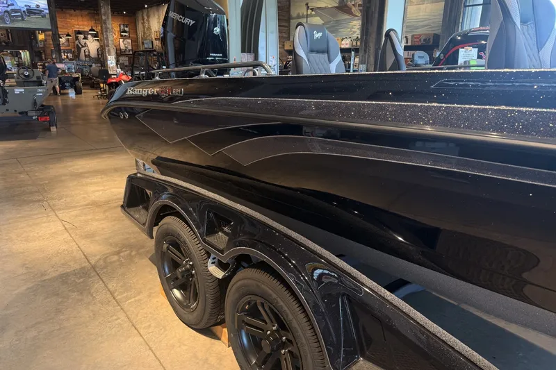Slide: The Image of 2026 Ranger 621FS Cup-Equipped boat in showroom, featuring sleek black design and Mercury engine. - 5
