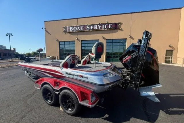 Slide: The Image of 2026 Ranger Z520R boat parked outside a boat service center. - 2