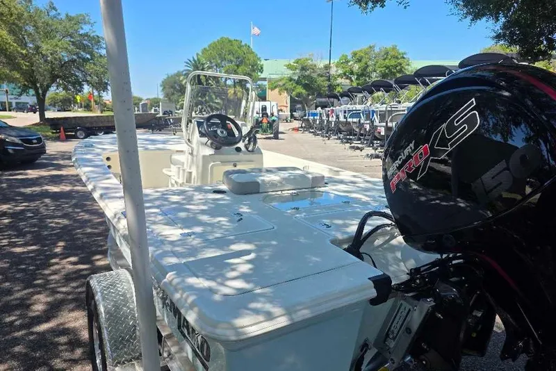 Slide: The Image of 2026 Mako 18 Pro Skiff boat with Mercury Pro XS engine in outdoor showroom. - 1