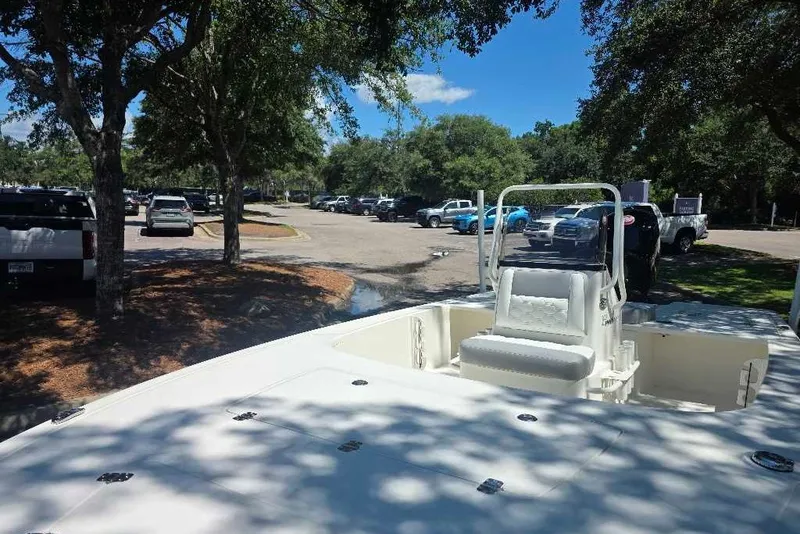 Slide: The Image of 2026 Mako 18 Pro Skiff boat parked under trees in a sunny parking lot. - 4