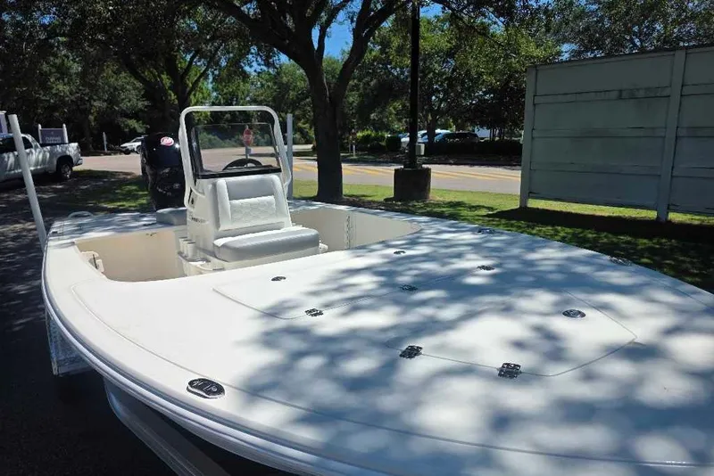 Slide: The Image of 2026 Mako 18 Pro Skiff boat parked outdoors under trees. - 5