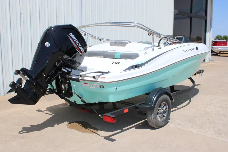 Slide: The Image of 2026 Tahoe T16 boat with Mercury engine on trailer, parked outdoors. - 4