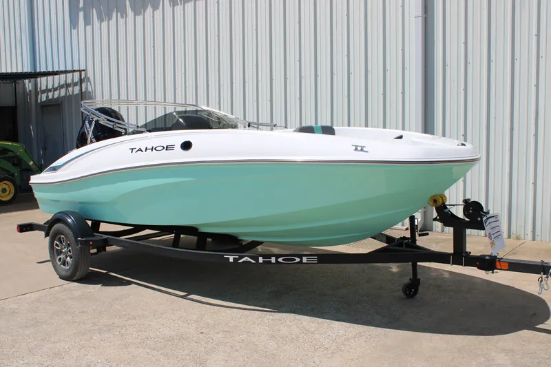 Slide: The Image of 2026 Tahoe T16 boat on trailer, mint green hull, parked outdoors. - 1