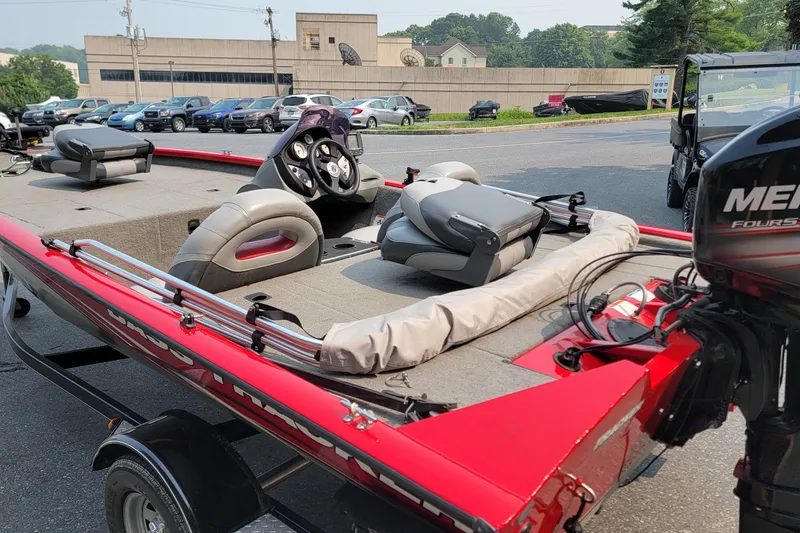 Slide: The Image of 2013 Tracker Pro Team 175 TXW boat with Mercury engine, parked outdoors. - 3