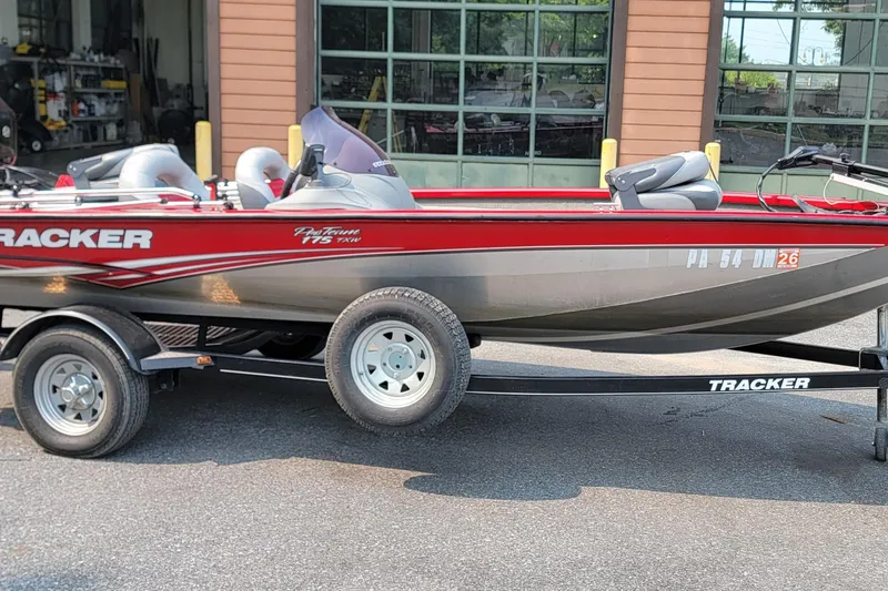 Slide: The Image of 2013 Tracker Pro Team 175 TXW boat on trailer, parked outside a garage. - 10