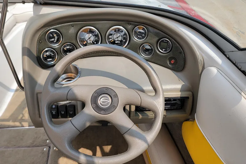 Slide: The Image of Dashboard of a 2007 Crownline 19 SS boat with steering wheel and gauges. - 10