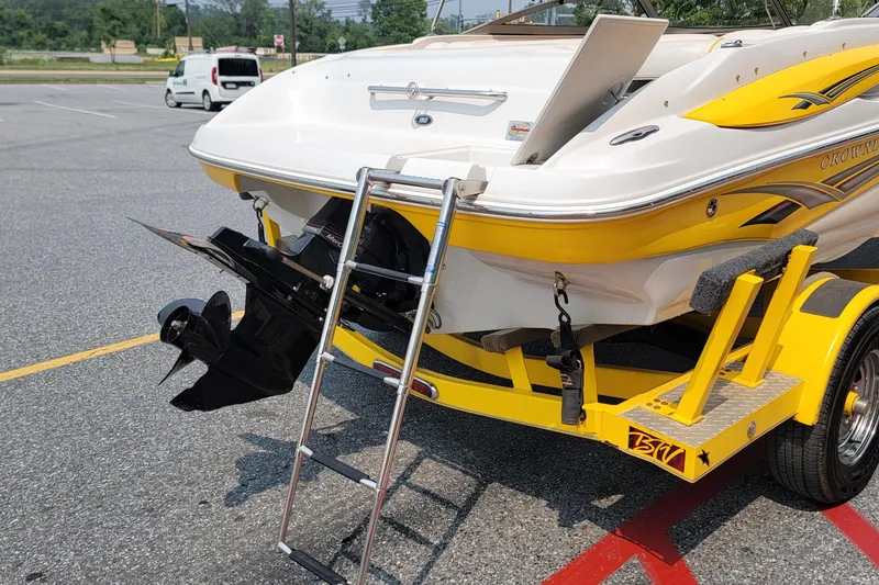 Slide: The Image of 2007 Crownline 19 SS boat on trailer with ladder and outboard motor in parking lot. - 5