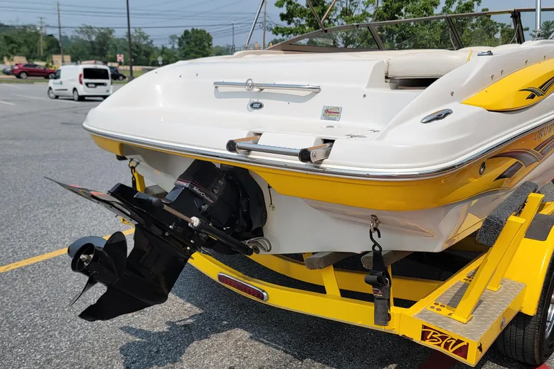 Slide: The Image of 2007 Crownline 19 SS boat on trailer, featuring a yellow and white design with visible outboard motor. - 3
