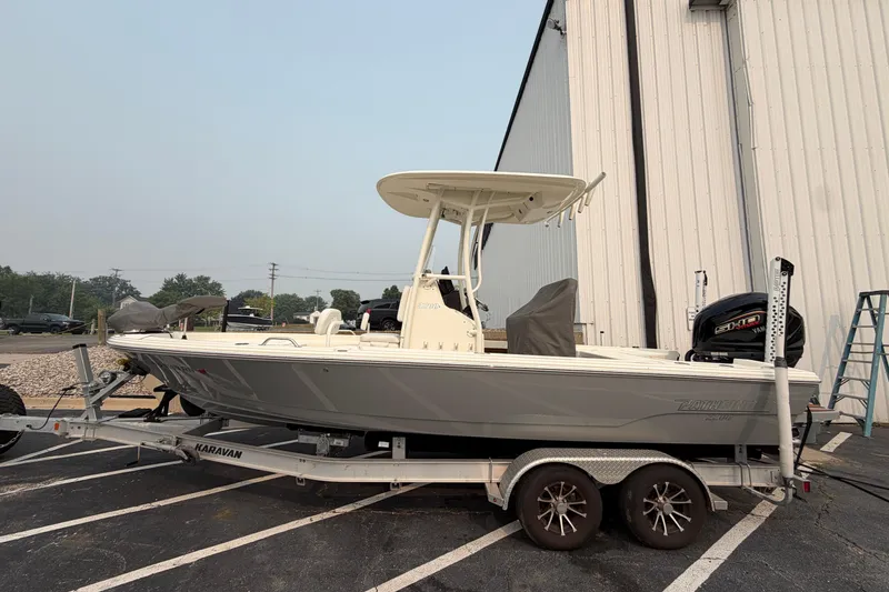 The Image of 2024 Pathfinder 2200 TRS boat on trailer, parked outside a building. - 0
