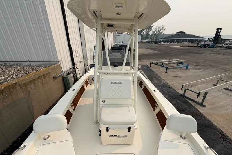 Slide: The Image of 2024 Pathfinder 2200 TRS boat docked, showcasing spacious deck and seating. - 14