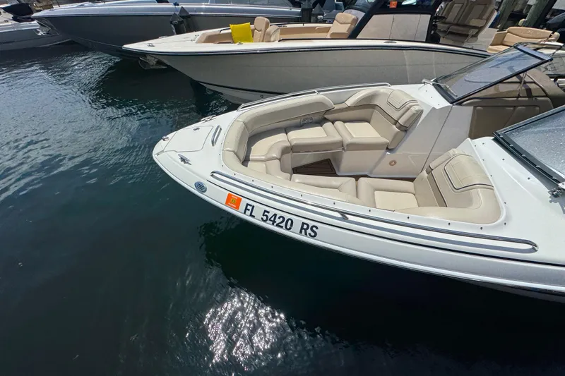 Slide: The Image of 2019 Formula 270 Bowrider boat docked, featuring spacious seating and sleek design. - 14