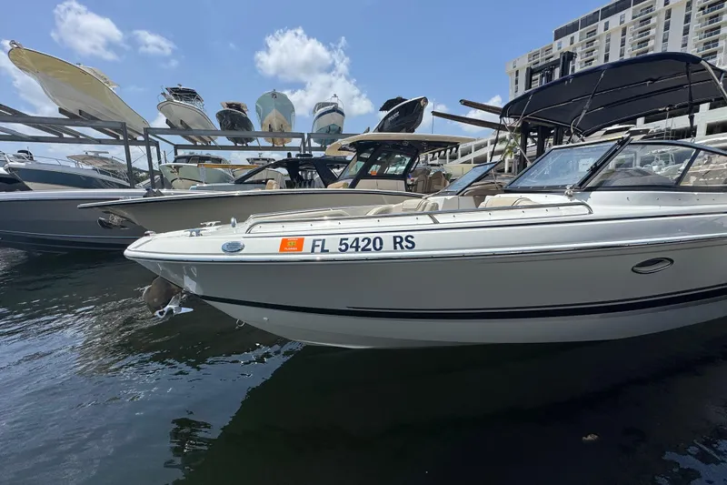 Slide: The Image of 2019 Formula 270 Bowrider docked, surrounded by other boats, under a clear sky. - 13