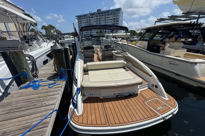 Slide: The Image of 2019 Formula 270 Bowrider docked at marina, featuring spacious seating and sleek design. - 10