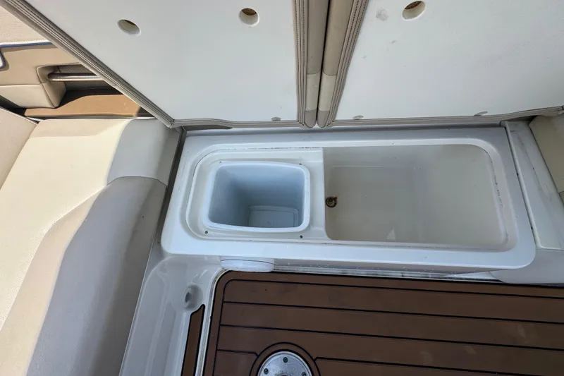 Slide: The Image of Open storage compartment on 2019 Formula 270 Bowrider boat, featuring a built-in cooler. - 22