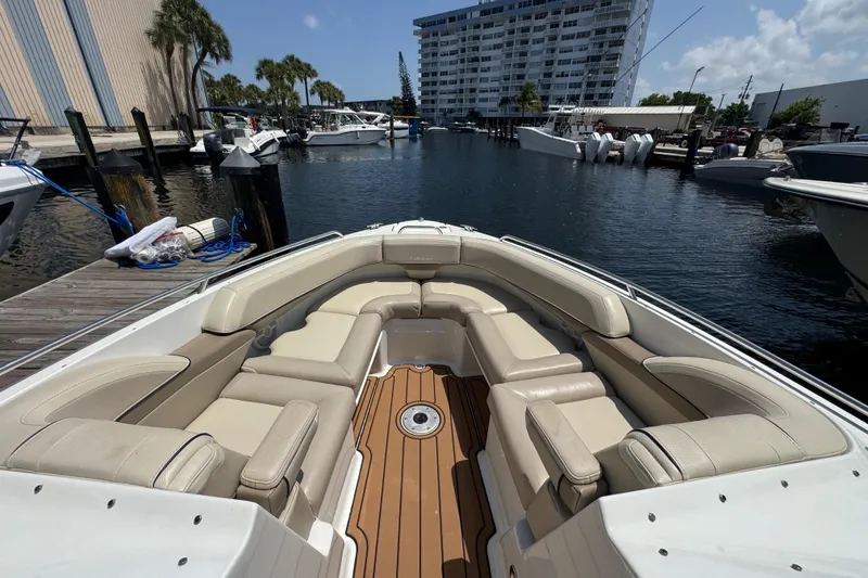 Slide: The Image of 2019 Formula 270 Bowrider with spacious seating docked at marina under clear skies. - 44