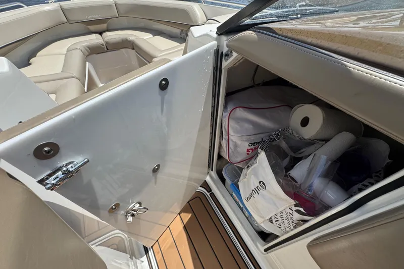 Slide: The Image of 2019 Formula 270 Bowrider interior storage with supplies and seating area. - 42